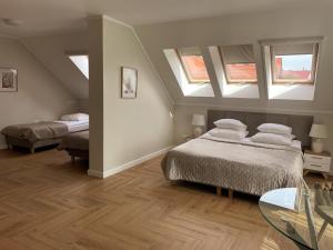 a bedroom with two beds and two windows at Hotel Santa Monica in Mikołajki