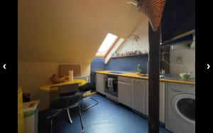 a small kitchen with a sink and a table at Spring Cuddle Nest in Berlin