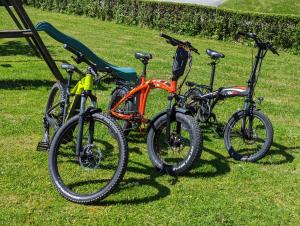 three bikes parked next to each other on the grass at Apartments Domačija Mlaker in Podčetrtek