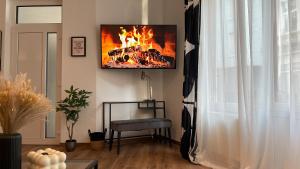 a living room with a fire on the wall at Gallery Apartment in Bonn