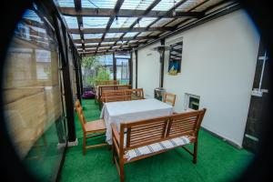 a room with a bed and chairs and a table at Căsuța DELDRADA in Câmpulung Moldovenesc