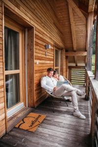 two people sitting in a sauna with a laptop at Exzelent Residence in Anterselva di Mezzo