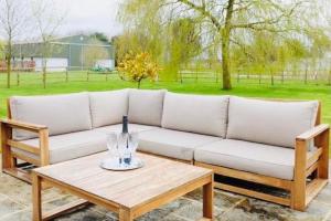 a white couch and a table with a bottle on it at Serene Luxury retreat near Newmarket, Exquisite amenities & Leisure in Brinkley