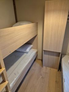 a small room with two bunk beds in it at Chalet maisonette dans hameau calme in Bonifacio