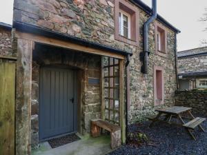 an entrance to a stone building with a blue door at Church How Cottage in Seascale