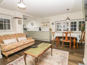 a living room with a couch and a table at Church How Cottage in Seascale
