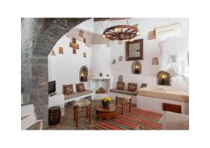 a living room with a couch and a table at Elounda Monastery Collection House in Epáno Eloúnda