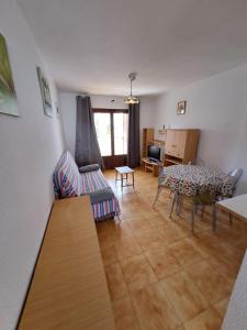 a living room with a table and a couch at Apartamentos Aldeas de Taray V.v. in La Manga del Mar Menor