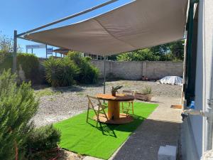 a patio with a table under an umbrella at Residenza Rogiò in Policoro