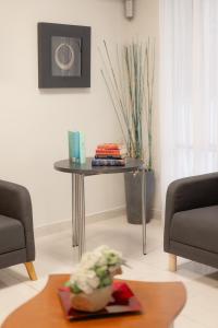 a living room with a table and two couches and a table at Hotel Santa Faz in Benidorm