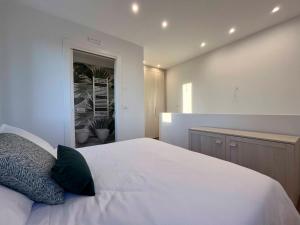 ein Schlafzimmer mit einem weißen Bett und einem grünen Kissen in der Unterkunft CasaTitti Polcenigo in San Giovanni