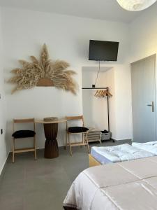a bedroom with a bed and a table and chairs at Ktimaoliva1 in Nafpaktos