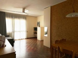 a living room with a table and a dining room at Residence Monica in Riva del Garda