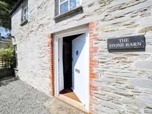 a brick building with a sign that reads the stone barn at Stone Barn in Camelford