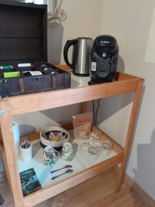 a shelf with a coffee maker and other items on it at Casa Mia, chambre privée en Provence in LʼIsle-sur-la-Sorgue