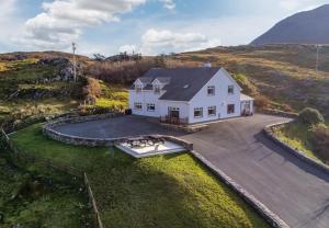 an aerial view of a house with a boat on a driveway at Glassillaun Beach House in Renvyle