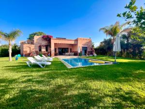 a house with a swimming pool in the yard at Entire villa with private pool in Marrakech in Marrakesh