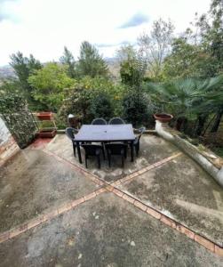a patio with a table and chairs in a yard at Casa indipendente con panorama stupendo in Montegiorgio +8 photos