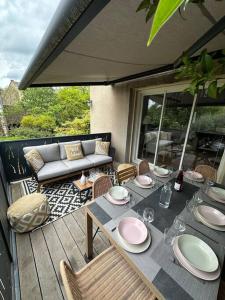a patio with a table and chairs and a couch at Magnifique mas provençal avec piscine au centre de Goudargues in Goudargues