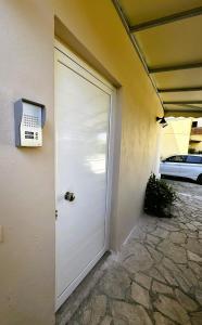 a white garage door with a air conditioner on it at ManosHouse in Kastanéa