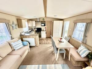 a living room with a couch and a table at Coastal Retreat a gorgeous 3 bedroom Caravan B46 in Everton
