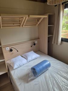 a bed in a bunk room with a blue tube on it at Chalet maisonette dans hameau calme in Bonifacio