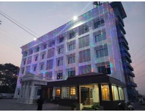 a building with christmas lights on the side of it at Hotel Rishivan Resort, Khopoli in Khopoli