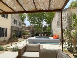 un patio trasero con piscina y una casa en La Feuilleraie, en Montséret