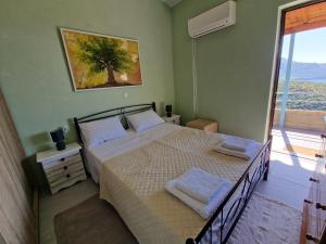 Ένα ή περισσότερα κρεβάτια σε δωμάτιο στο Archontoula's villa