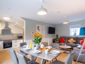 a living room with a table and a couch at E2 Station House in Clifden