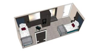 a floor plan of a room with two beds at Zentrum Hotel Stade in Stade