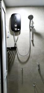 a shower in a bathroom with a blow dryer at Guesthouse@ Bukit Bintang in Kuala Lumpur