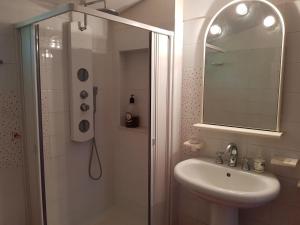 a bathroom with a shower and a sink and a mirror at B&B Cactus in Giardini Naxos