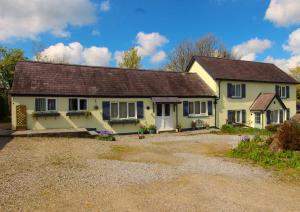 a yellow house with a brown roof at Blaencwm Cottages in Boncath
