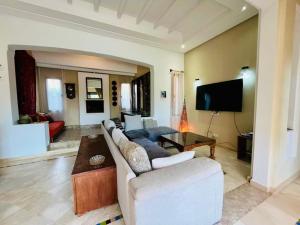 a living room with a couch and a table at Entire villa with private pool in Marrakech in Marrakesh