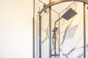 a glass door with a microphone next to a wall at Sandside Beachfront Cottage Perfectly Saltburn in Saltburn-by-the-Sea +18 photos