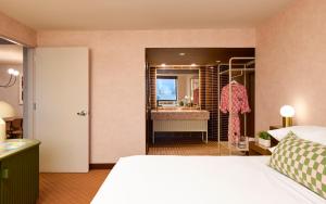 a hotel room with a bed and a bathroom at Downright Austin, A Renaissance Hotel - New Hotel in Austin