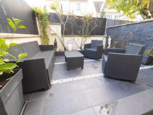 a patio with a bunch of chairs and tables at TEA&CHILL- Les Bluets - house with 2 terraces in Noisy-le-Sec