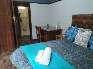 a bedroom with a bed with towels on it at Fair Haven in Bloemfontein