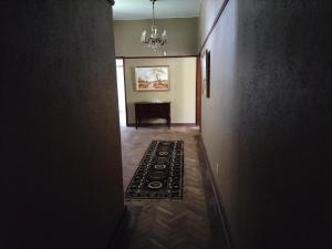 a hallway with a room with a piano and a rug at Fair Haven in Bloemfontein