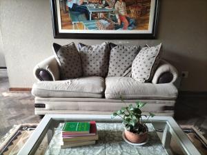 a living room with a couch and a coffee table at Fair Haven in Bloemfontein