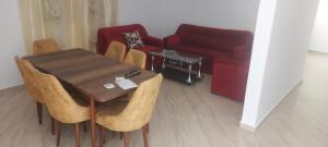 a living room with a table and chairs and a couch at Villa bien equiper a saidia pres de la plage in Saidia 