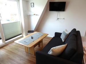 TV a/nebo společenská místnost v ubytování Lütt Plambeck-Appartement Inge DG 6