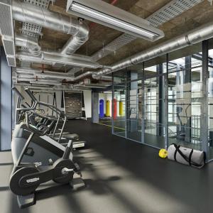 a gym with a treadmill and a exercise bike at Homely 2-Bed Apartment with stunning Views Wembley in London