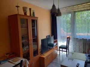 a living room with a large window and a television at zwykłe mieszkanie dla zwykłych ludzi in Wałbrzych