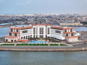 an aerial view of a large white building next to the water at Djibouti Ayla Grand Hotel in Djibouti