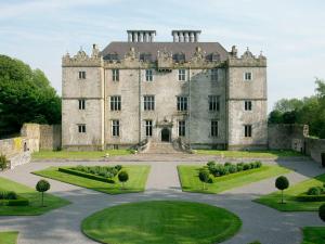 an old castle with a garden in front of it at Loughrea Hotel & Spa in Loughrea