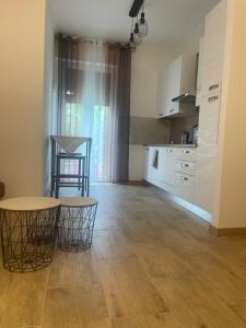a kitchen with a table and two stools in a room at B&B Aeroporto in Azzano San Paolo