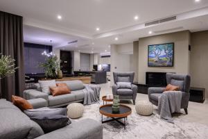 a living room with couches and chairs and a television at Luxury Villa Mikolina in Kornić