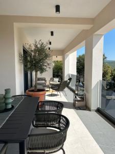 a patio with a table and chairs and a table at Luxury Villa Mikolina in Kornić